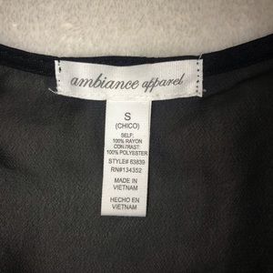 Ambiance Apparel black sleeveless top with bow on front. Size S